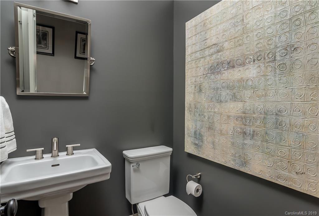 2634 Sharon Road Charlotte, NC 28211 - Photo 33 of 46 a bathroom with a sink a toilet and mirror