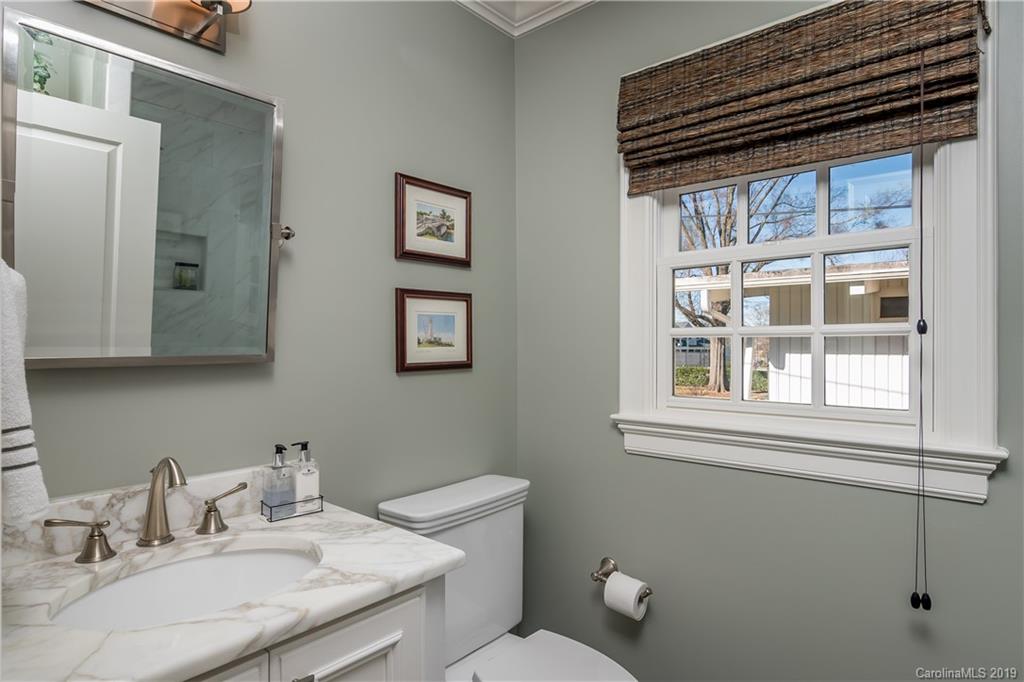 2634 Sharon Road Charlotte, NC 28211 - Photo 35 of 46 a bathroom with a granite countertop sink mirror and a toilet