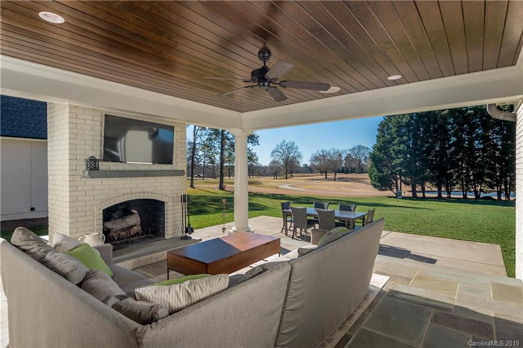 2634 Sharon Road Charlotte, NC 28211 - Photo 38 of 46 a living room with patio furniture and a fireplace