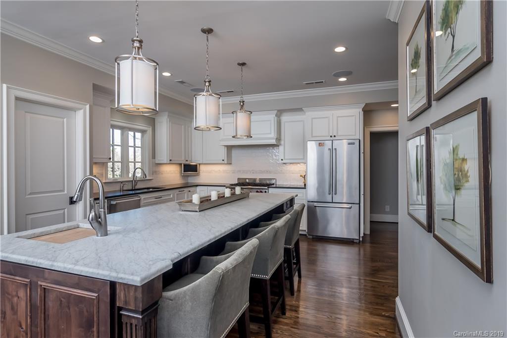 2634 Sharon Road Charlotte, NC 28211 - Photo 10 of 46 a kitchen with stainless steel appliances granite countertop a sink a stove and a refrigerator