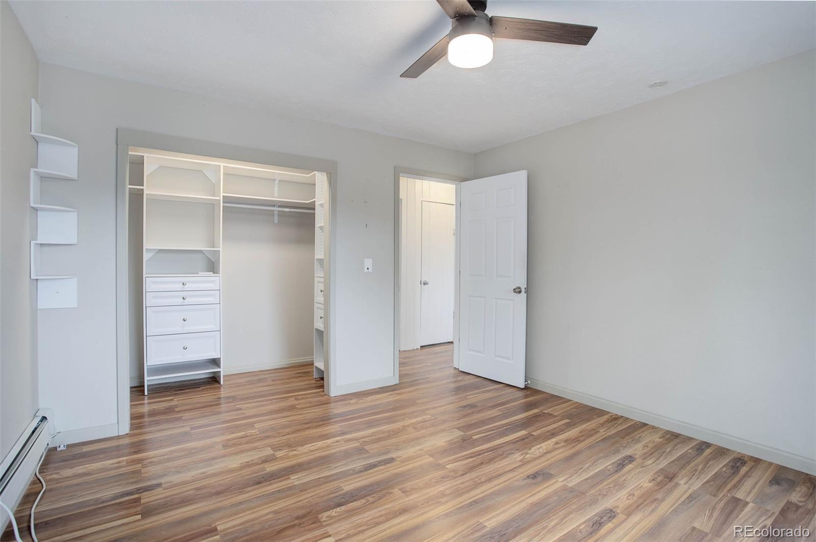 27857 Apex Circle Evergreen, CO 80439 - Photo 14 of 37 an empty room with wooden floor closet and windows