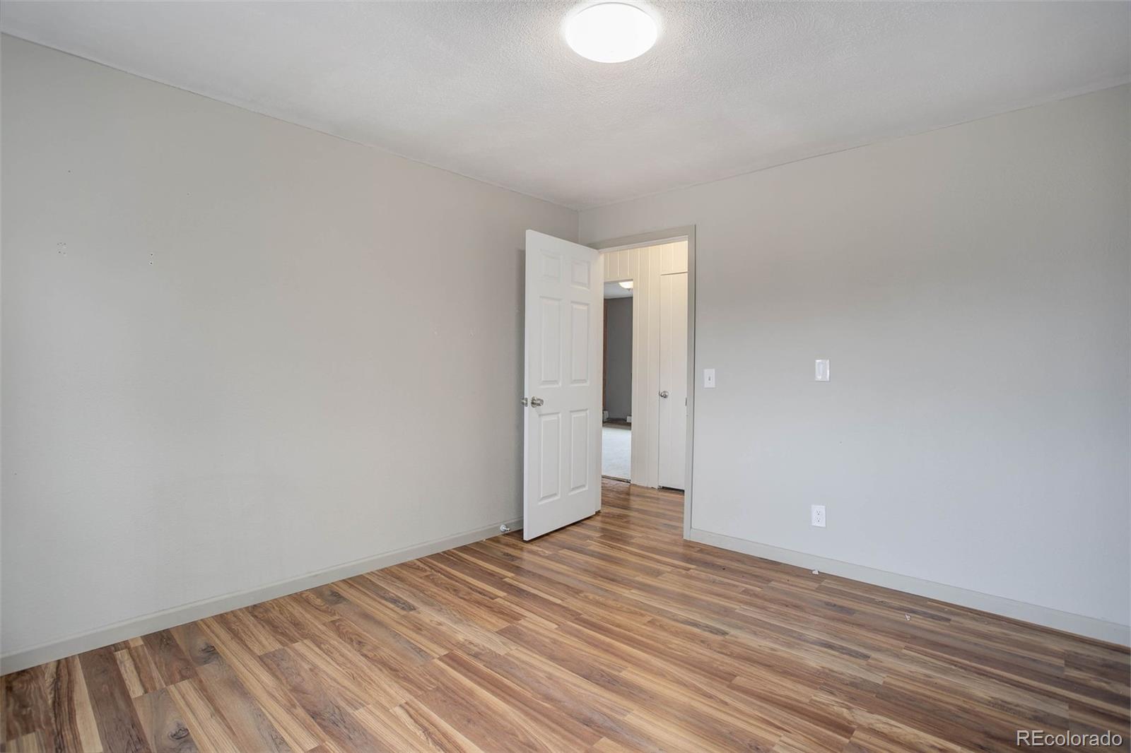 27857 Apex Circle Evergreen, CO 80439 - Photo 17 of 37 a view of a room with wooden floor and white walls
