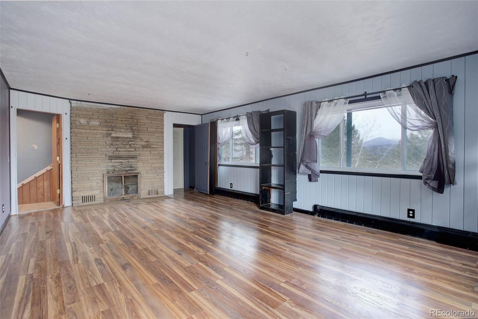 27857 Apex Circle Evergreen, CO 80439 - Photo 23 of 37 a view of an empty room with wooden floor and a window