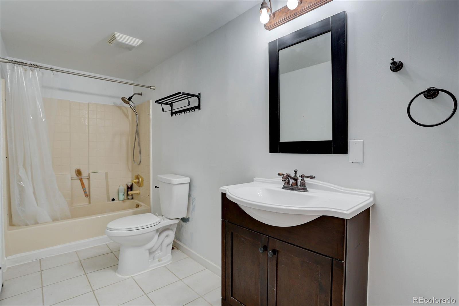 27857 Apex Circle Evergreen, CO 80439 - Photo 25 of 37 a bathroom with a sink toilet and shower