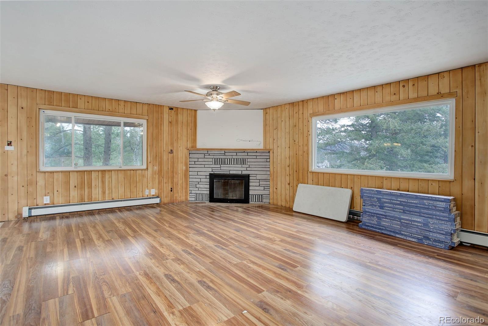 27857 Apex Circle Evergreen, CO 80439 - Photo 5 of 37 wooden floor fireplace and windows in an empty room