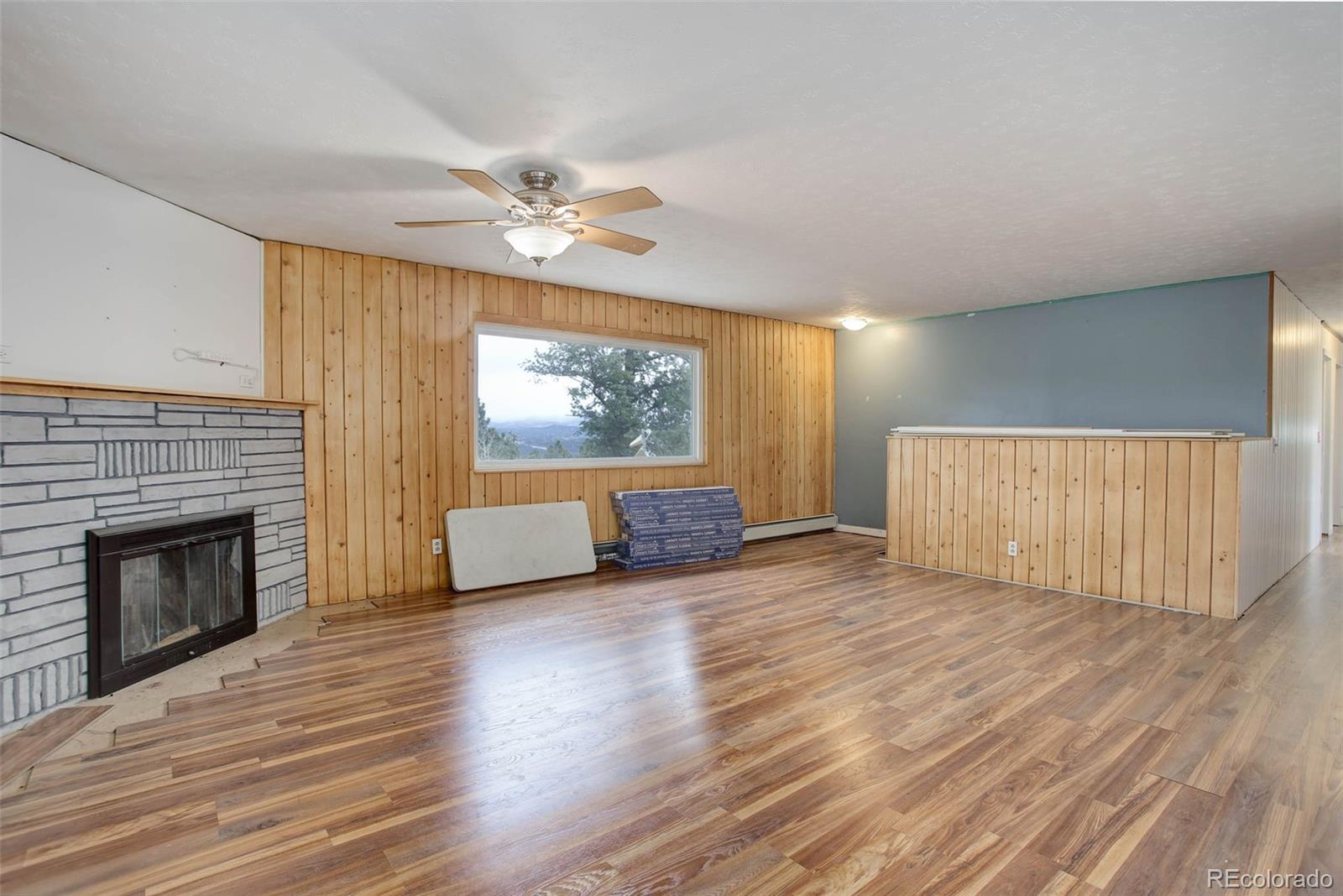 27857 Apex Circle Evergreen, CO 80439 - Photo 6 of 37 a view of an empty room with a fireplace and a window