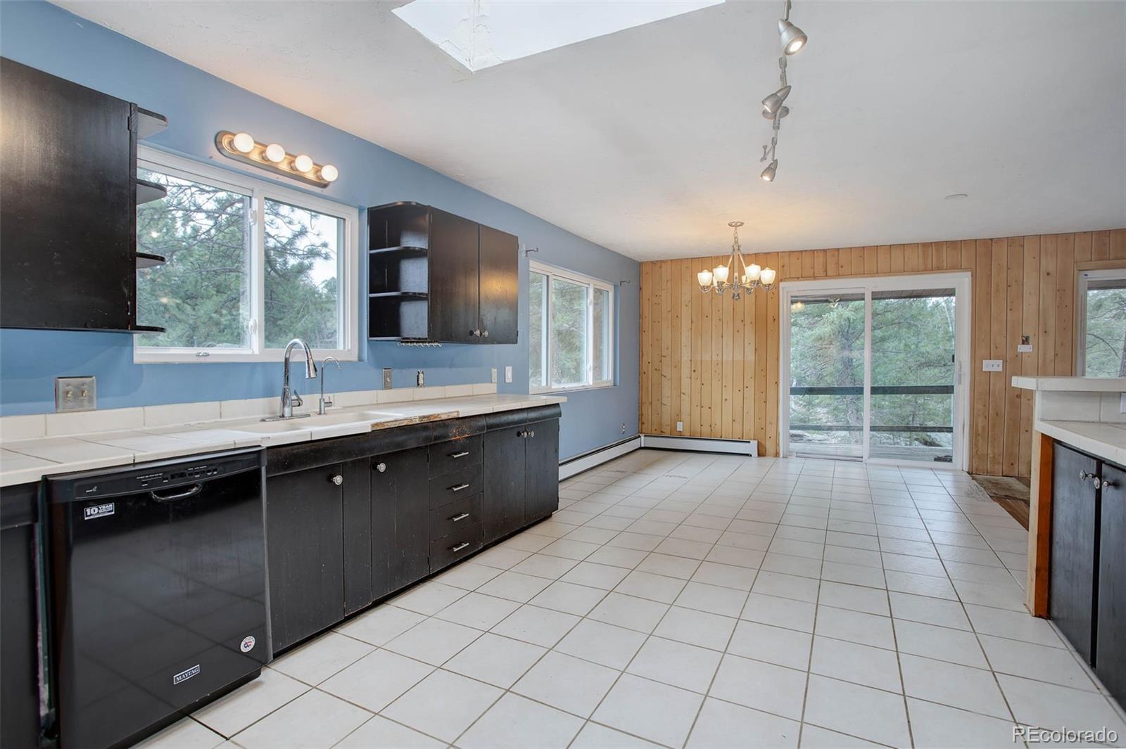 27857 Apex Circle Evergreen, CO 80439 - Photo 7 of 37 a large kitchen with a large window and cabinets