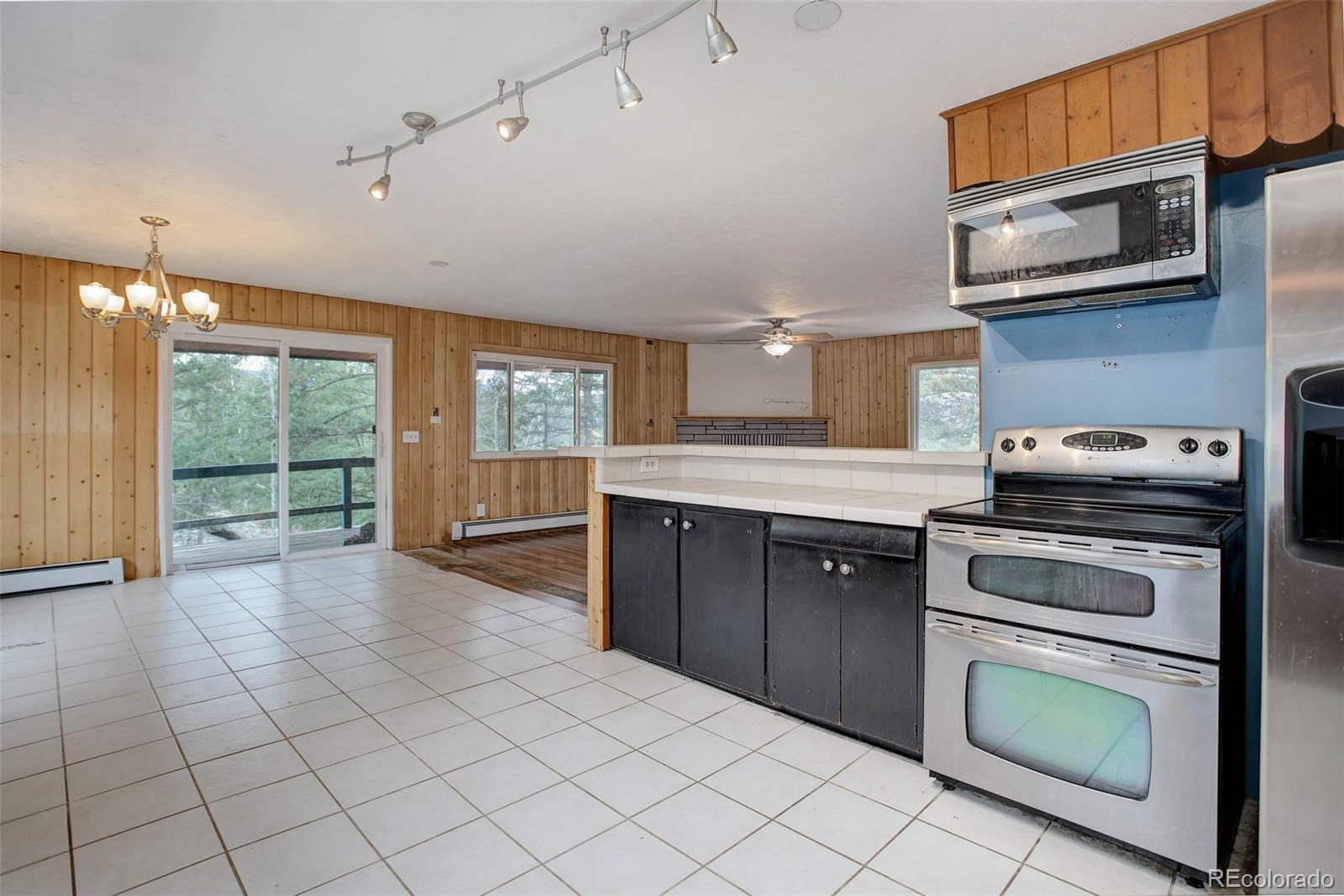 27857 Apex Circle Evergreen, CO 80439 - Photo 10 of 37 a kitchen with stainless steel appliances granite countertop a stove a sink and a microwave
