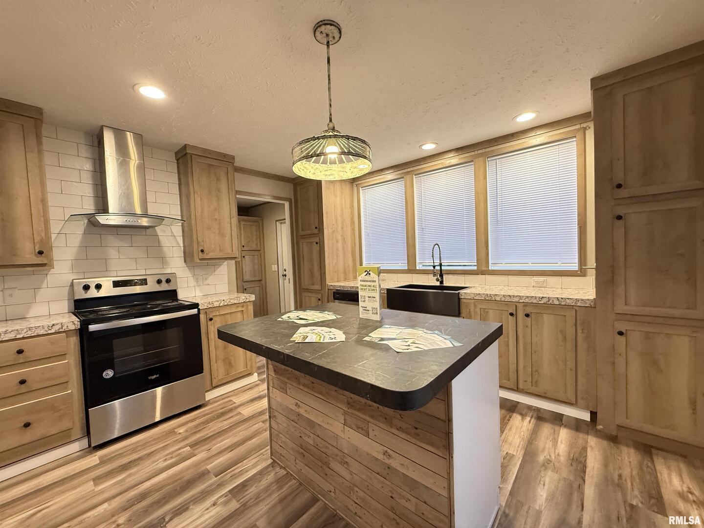 9049 Grassy Road Marion, IL 62959 - Photo 11 of 45 a kitchen with a stove a sink and a refrigerator
