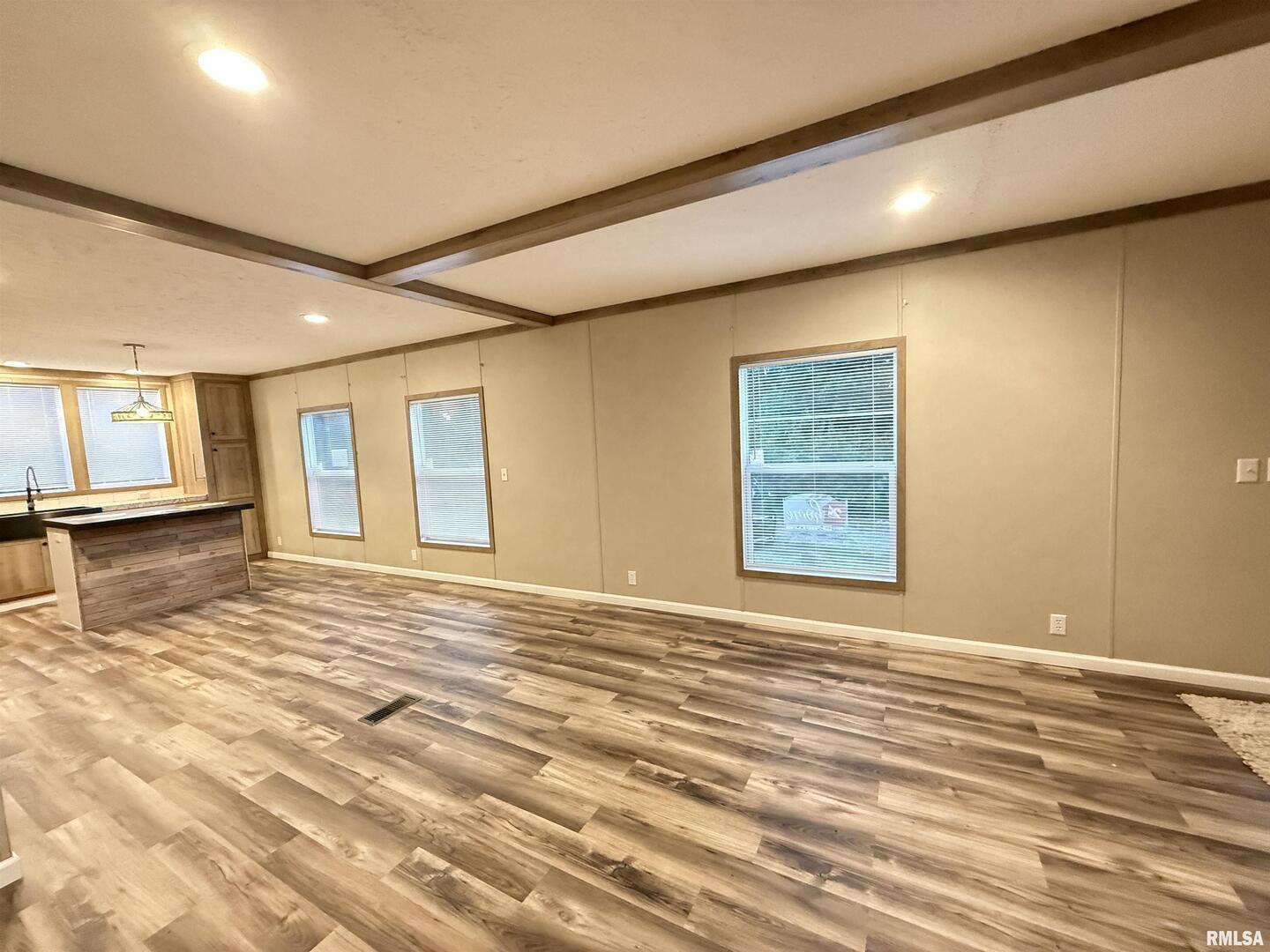 9049 Grassy Road Marion, IL 62959 - Photo 13 of 45 a view of an empty room with wooden floor and a window