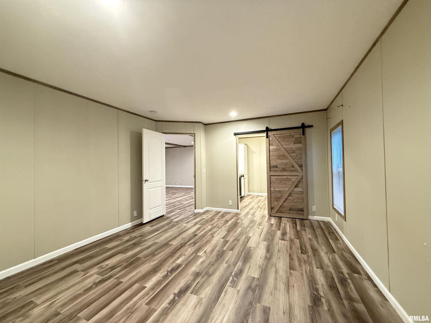 9049 Grassy Road Marion, IL 62959 - Photo 14 of 45 a view of empty room with wooden floor and fan