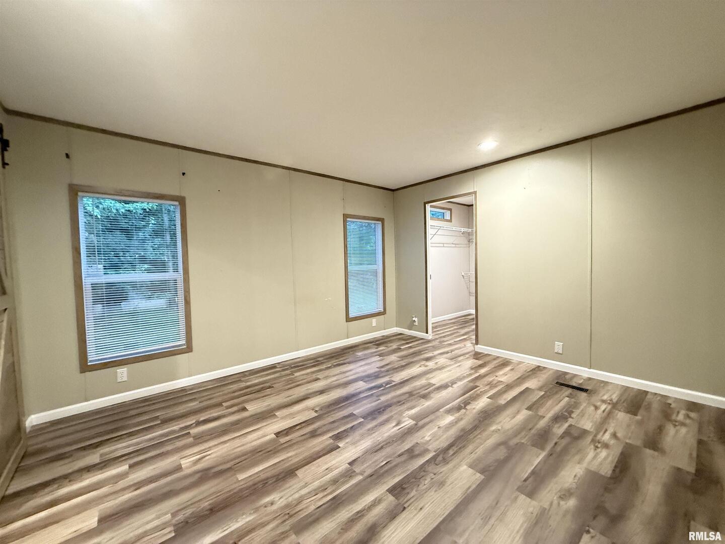 9049 Grassy Road Marion, IL 62959 - Photo 15 of 45 a view of an empty room with wooden floor and a window