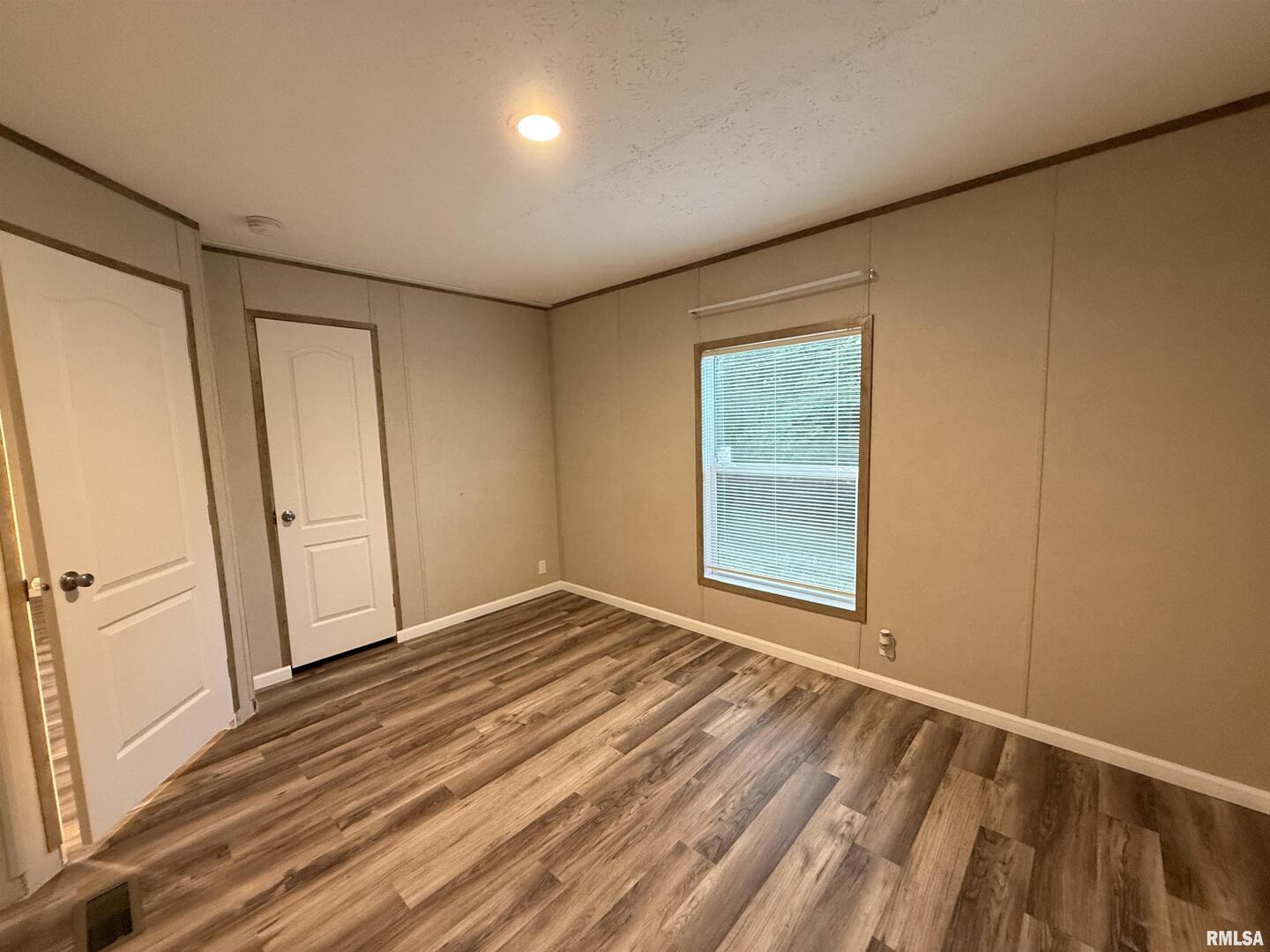 9049 Grassy Road Marion, IL 62959 - Photo 24 of 45 a view of an empty room with wooden floor and a window