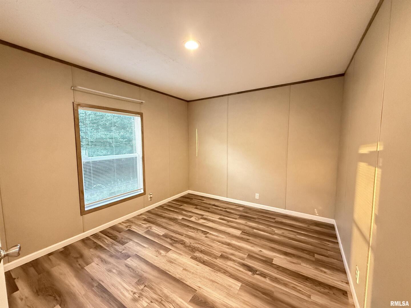 9049 Grassy Road Marion, IL 62959 - Photo 25 of 45 a view of empty room with wooden floor and fan