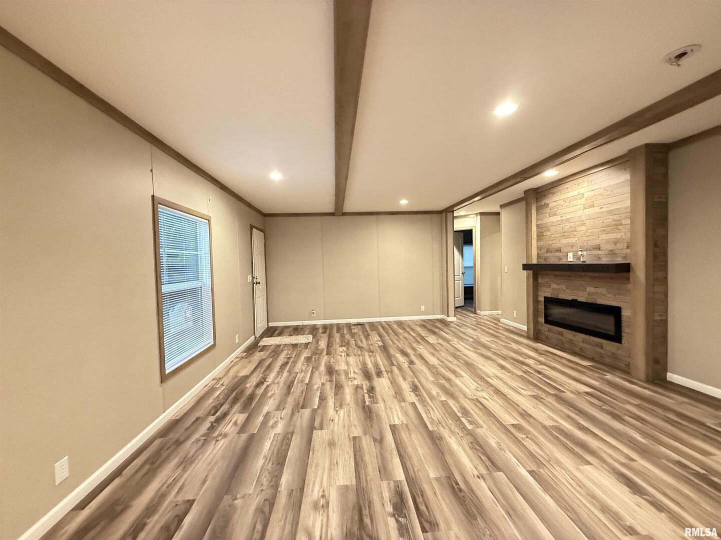 9049 Grassy Road Marion, IL 62959 - Photo 3 of 45 a view of empty room with wooden floor and fireplace