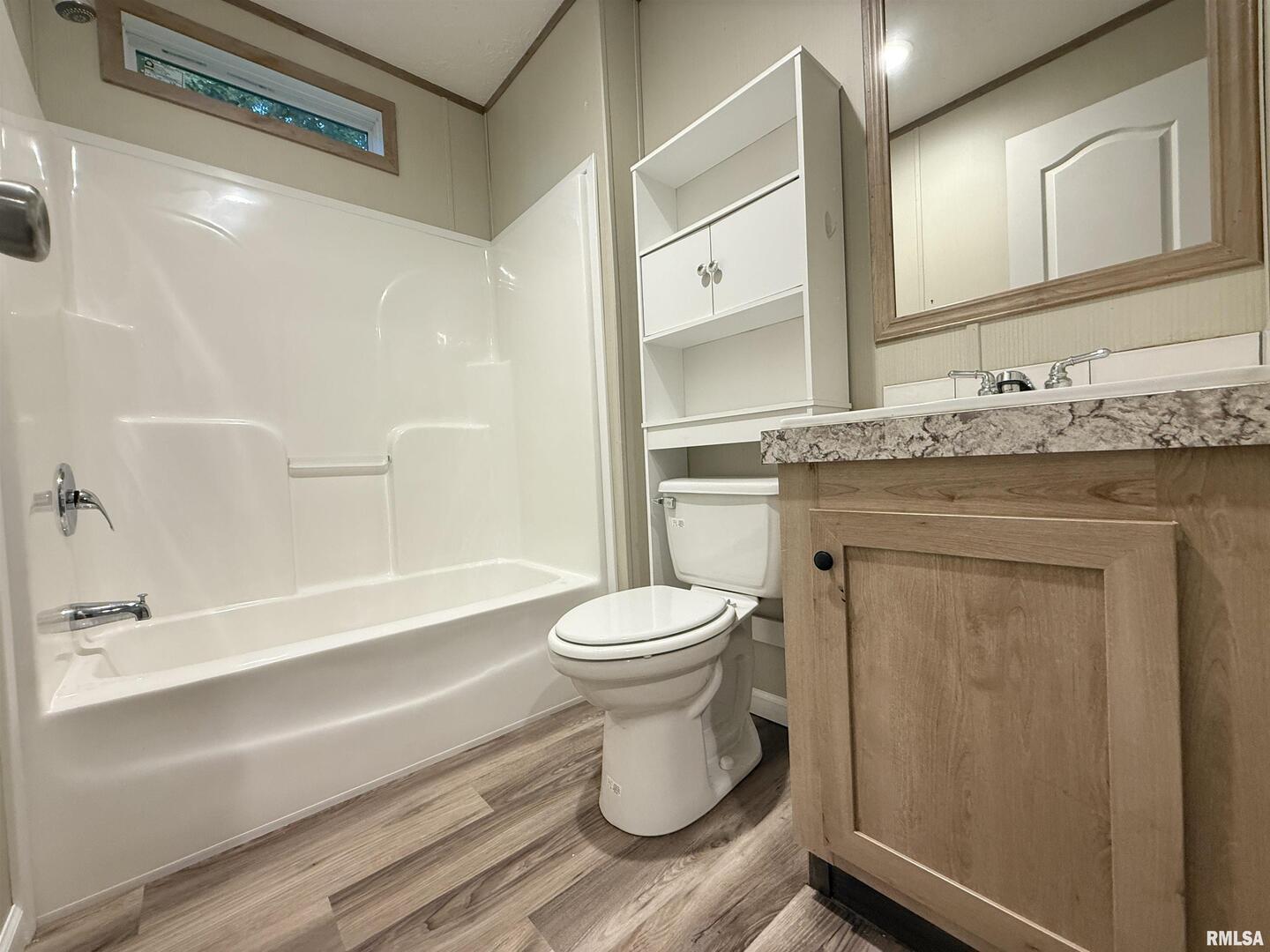 9049 Grassy Road Marion, IL 62959 - Photo 33 of 45 a bathroom with a granite countertop toilet sink and mirror