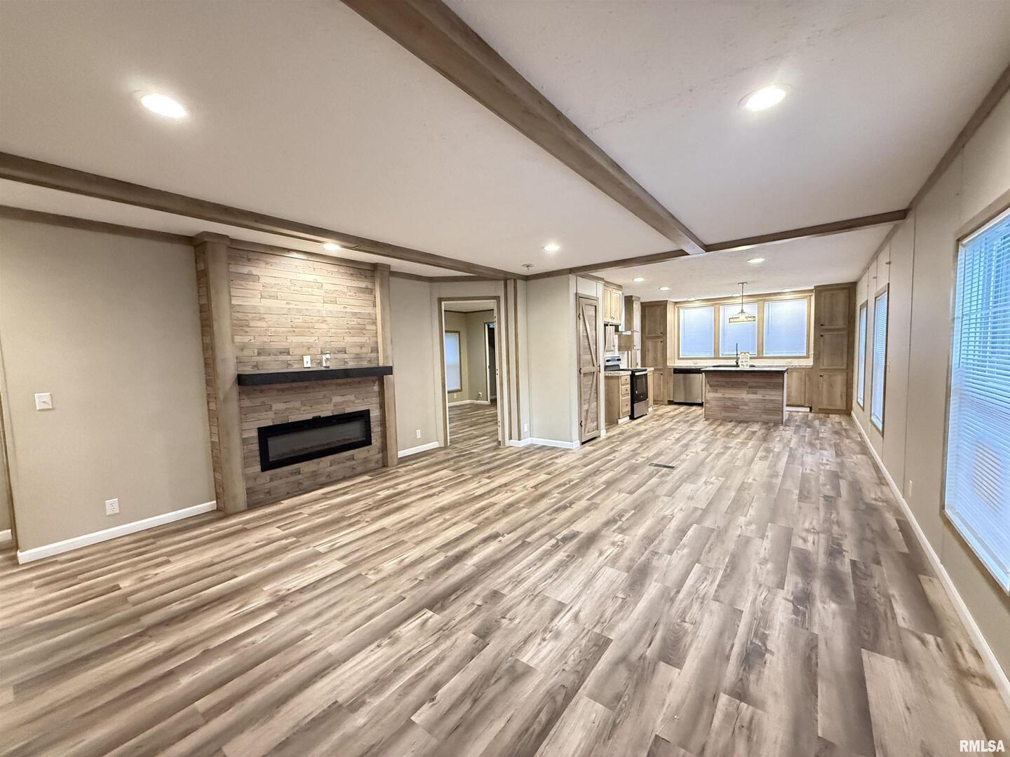 9049 Grassy Road Marion, IL 62959 - Photo 9 of 45 a view of empty room with wooden floor and fireplace
