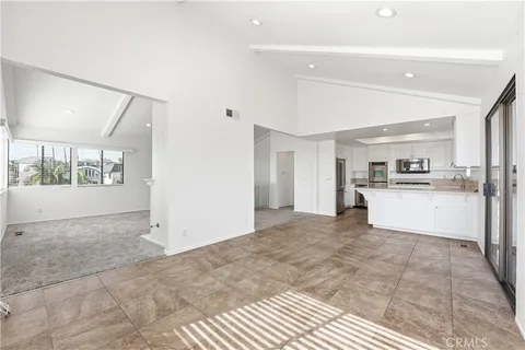 a view of kitchen with refrigerator and window
