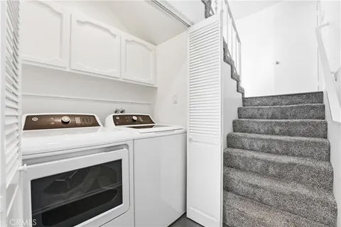 a kitchen with a stove and white cabinets