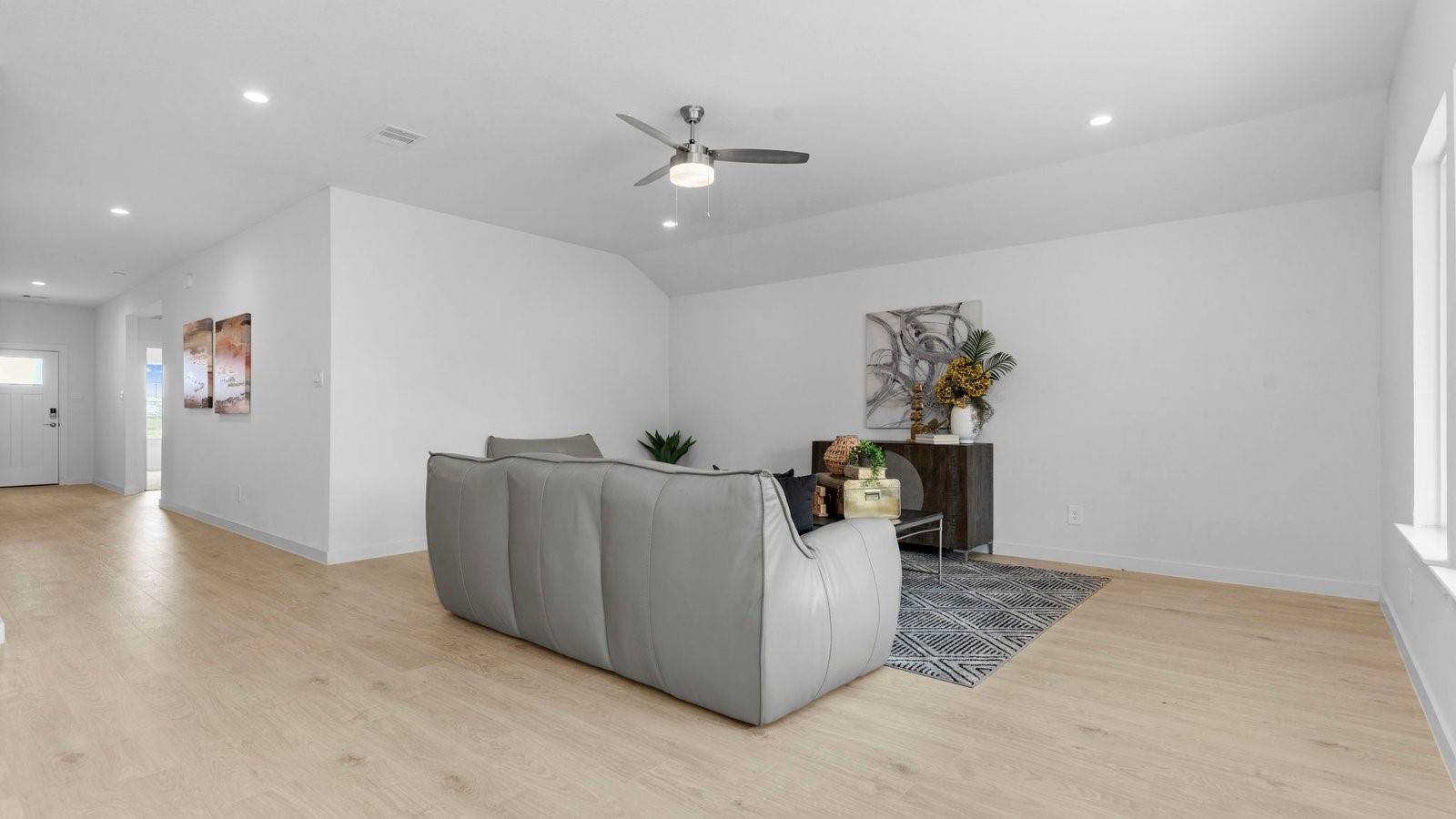 31306 Mila Cove Fulshear, TX 77441 - Photo 14 of 48 a living room with couches and kitchen view with wooden floor