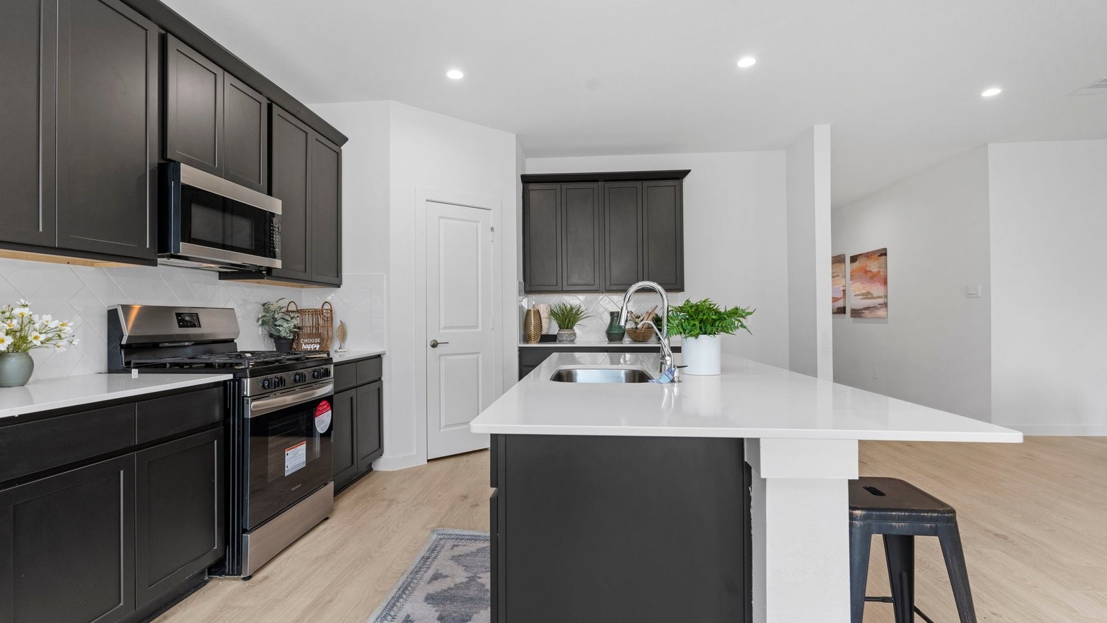 31306 Mila Cove Fulshear, TX 77441 - Photo 19 of 48 a kitchen with stainless steel appliances granite countertop a sink stove and refrigerator