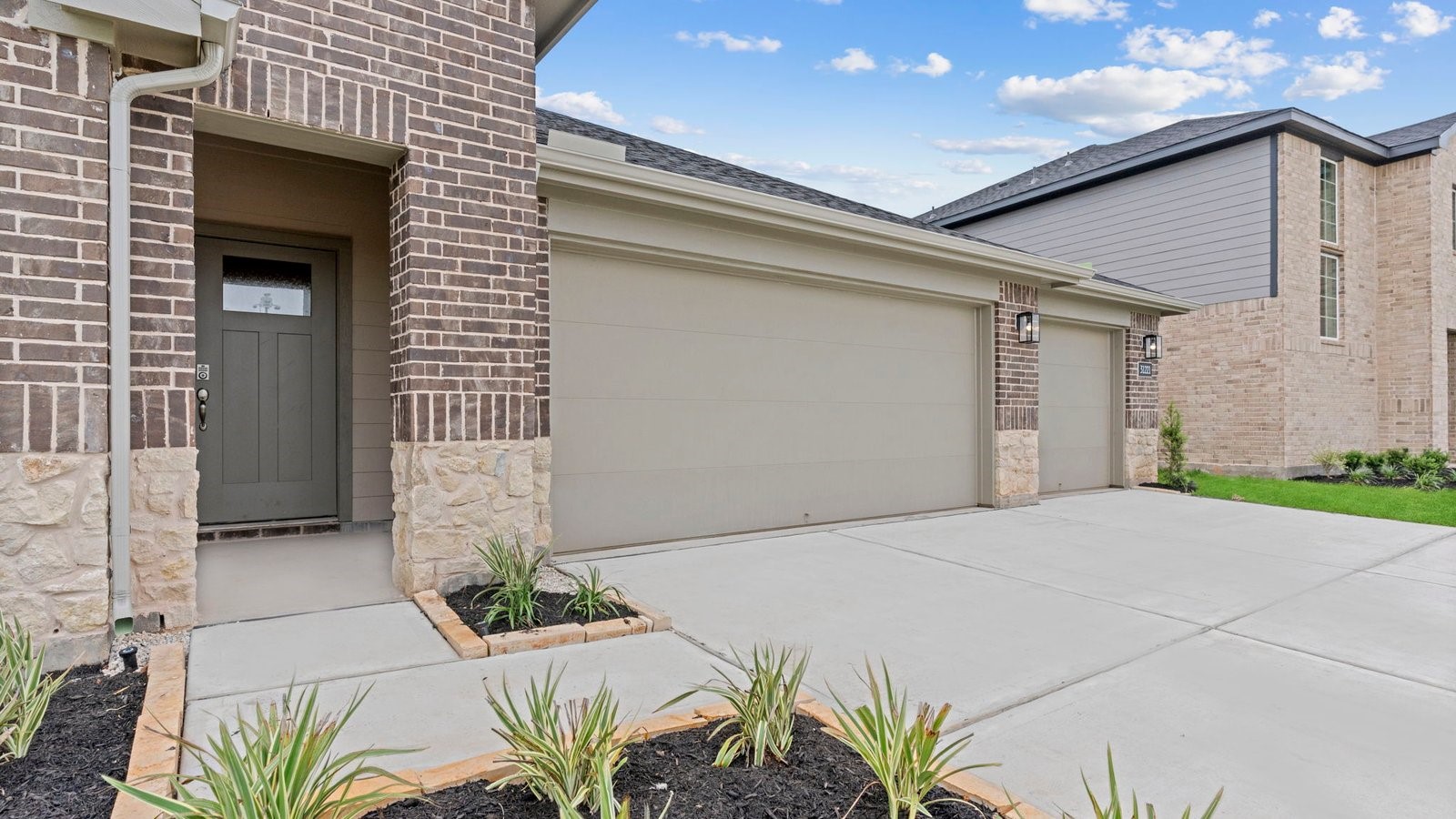 31306 Mila Cove Fulshear, TX 77441 - Photo 2 of 48 a front view of a house with a yard and garage