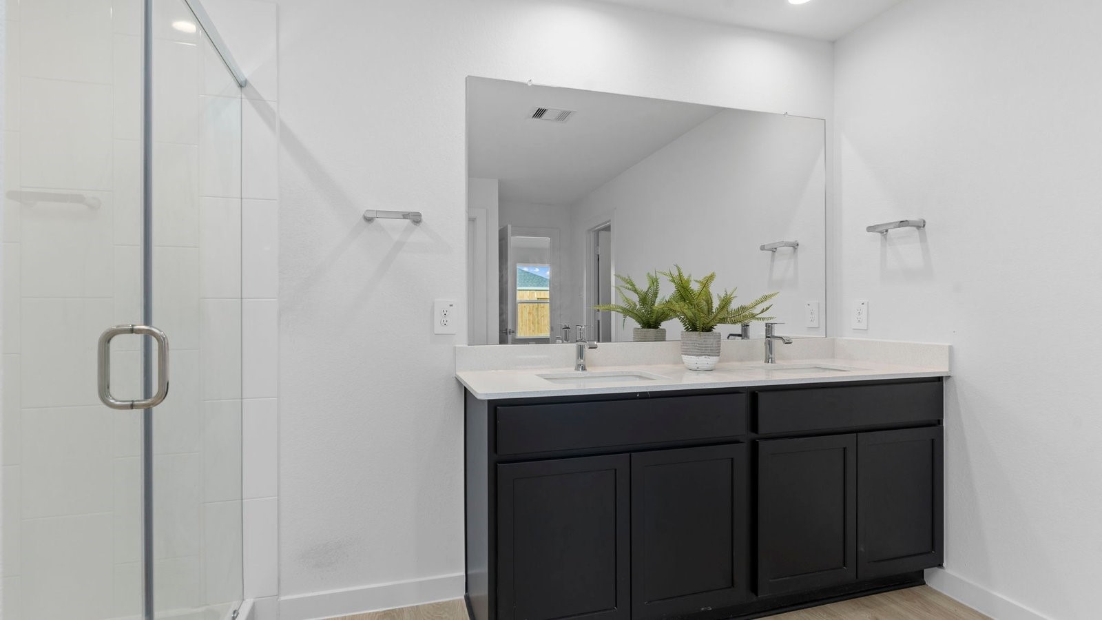 31306 Mila Cove Fulshear, TX 77441 - Photo 26 of 48 a bathroom with a double vanity sink and mirror