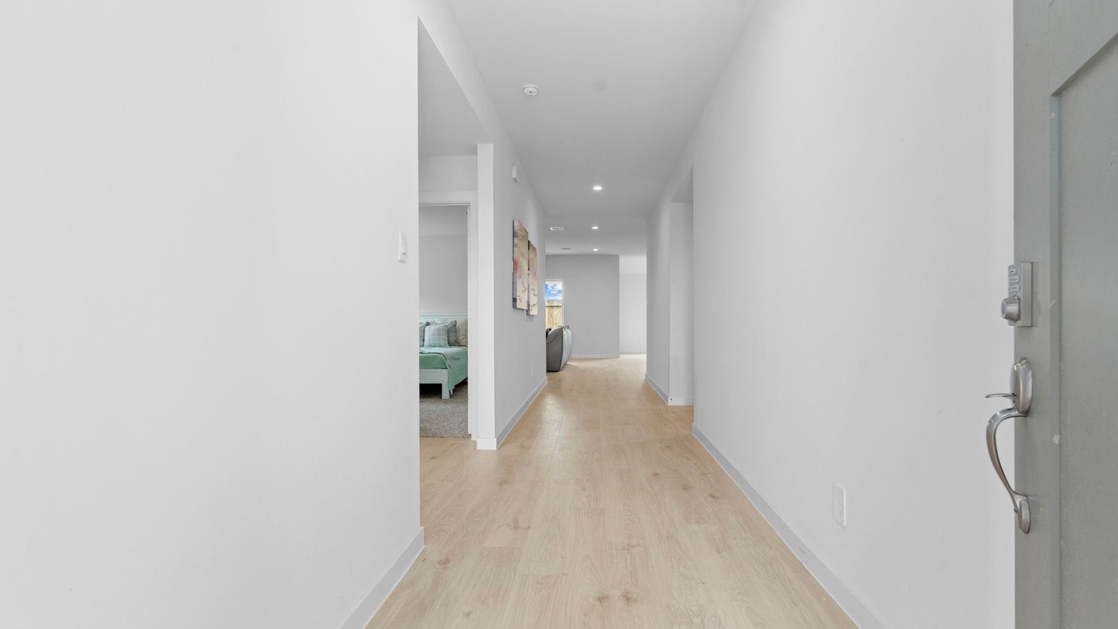 31306 Mila Cove Fulshear, TX 77441 - Photo 3 of 48 a view of a hallway with wooden floor