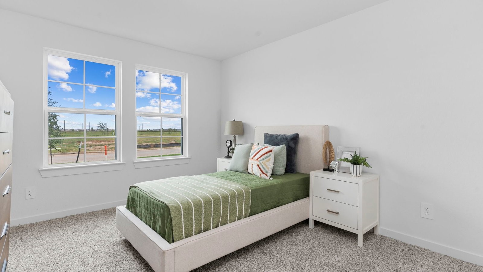 31306 Mila Cove Fulshear, TX 77441 - Photo 4 of 48 a bedroom with a bed and window