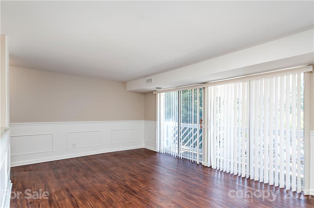 9405 Old Concord Road, Unit J Charlotte, NC 28213 - Photo 7 of 15 wooden floor in an empty room with a window