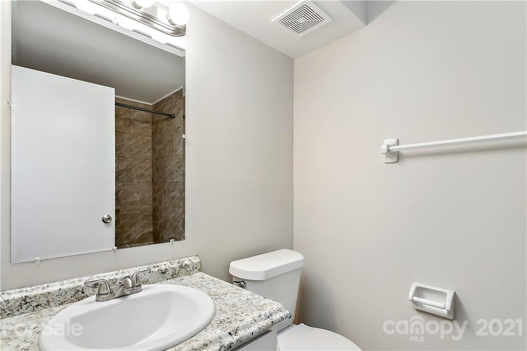 9405 Old Concord Road, Unit J Charlotte, NC 28213 - Photo 10 of 15 a bathroom with a granite countertop sink and a mirror