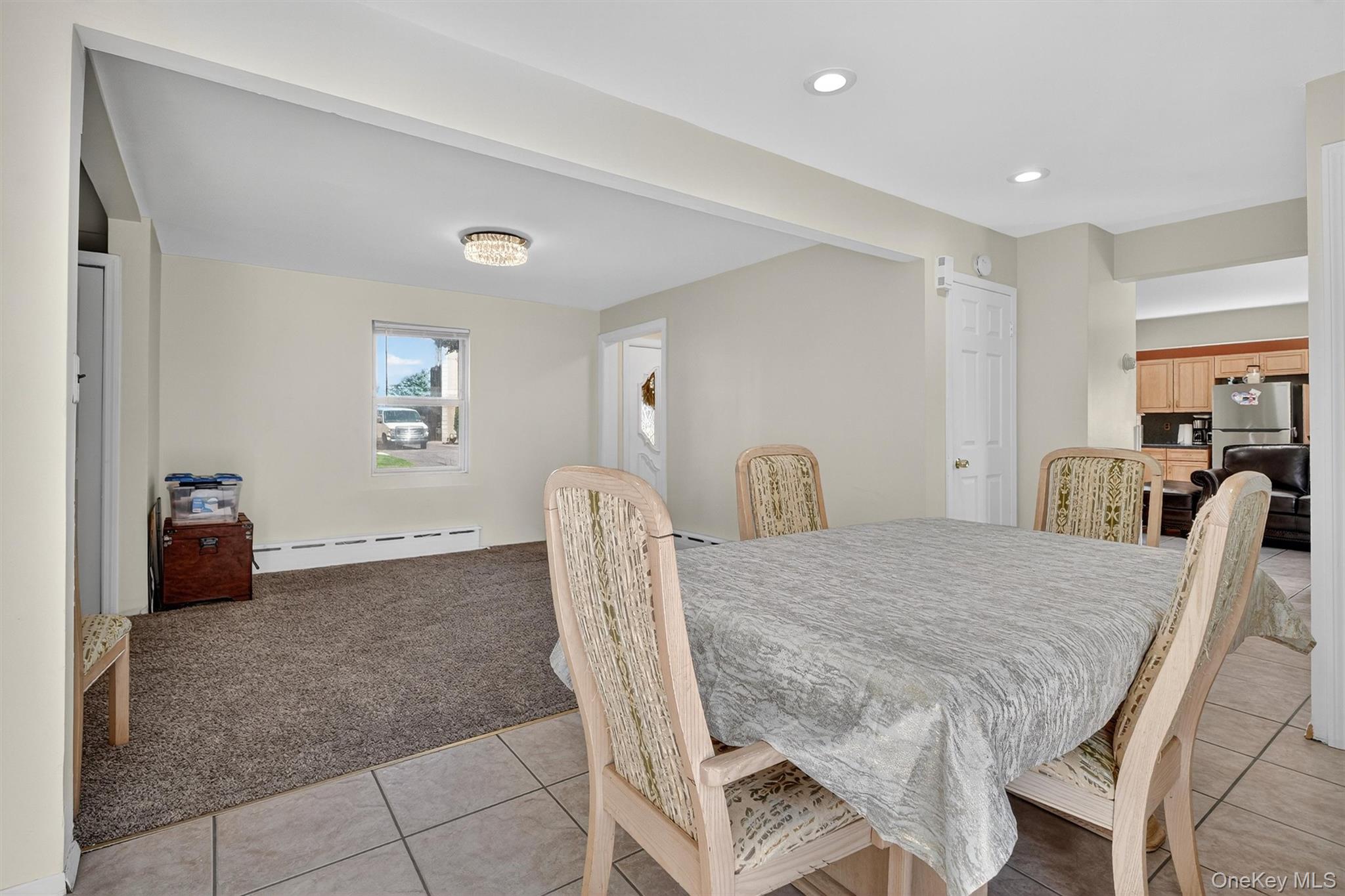 3384 Country Club Road Bronx, NY 10465 - Photo 21 of 48 Dining space featuring light colored carpet, a baseboard heating unit, light tile patterned floors, and recessed lighting