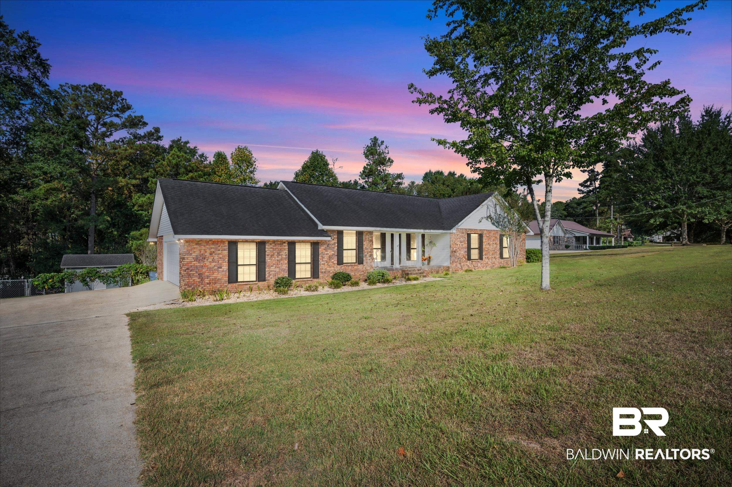 550 Norwood Road Monroeville, AL 36460 - Photo 1 of 46 Single story home with a front yard, concrete driveway, a shingled roof, covered porch, and brick siding