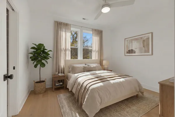 a bedroom with a bed and a potted plant