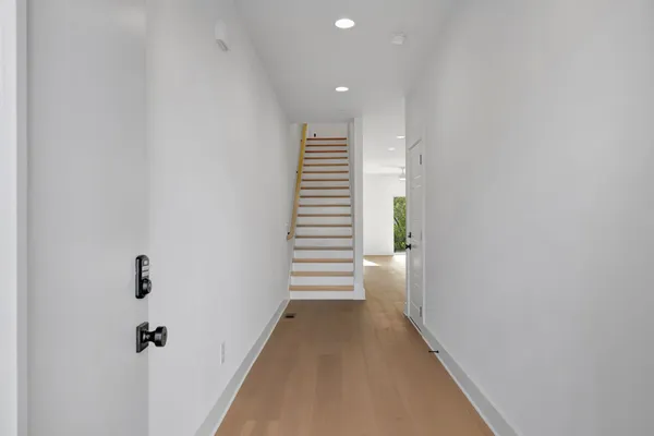 a view of a hallway with stairs