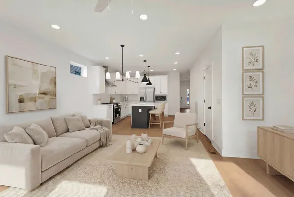 a living room with furniture and kitchen view
