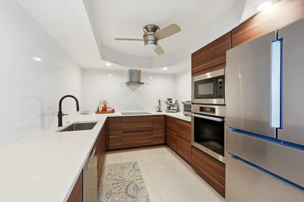 a kitchen with stainless steel appliances granite countertop a sink and a stove