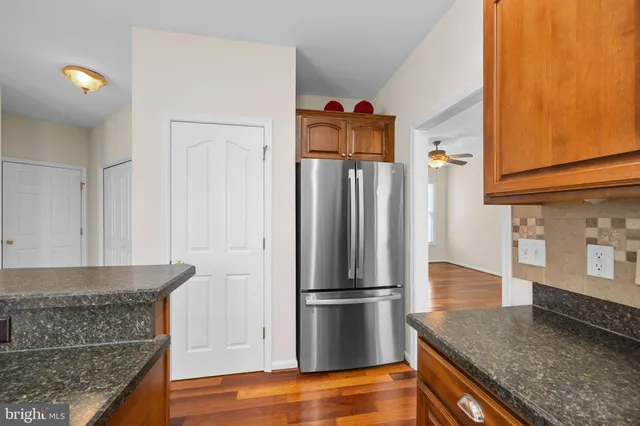 a view of an empty room with a window and a fireplace