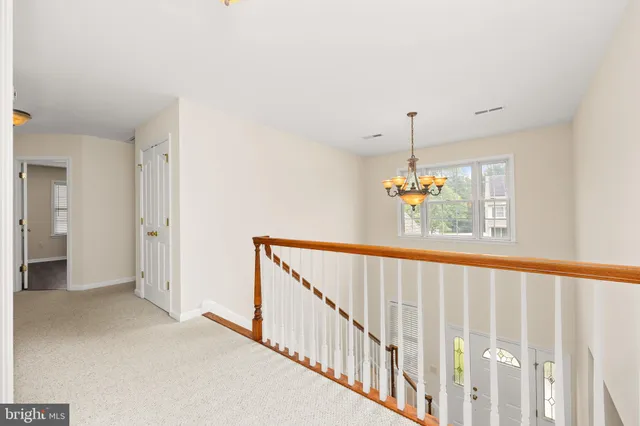 a spacious bathroom with a double vanity sink a toilet and a mirror