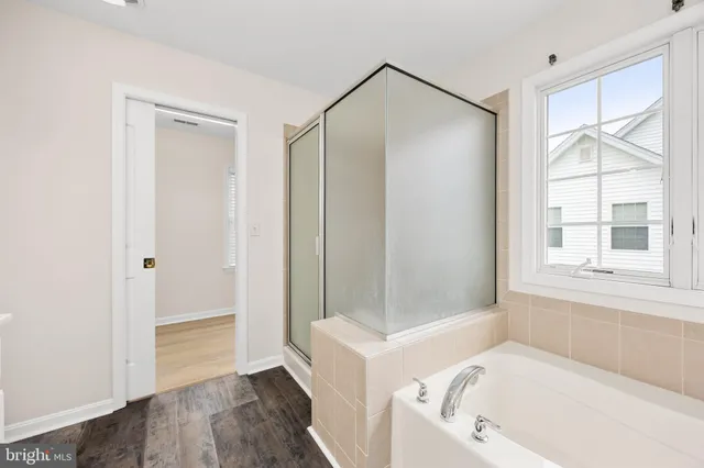 an empty room with a ceiling fan and a window