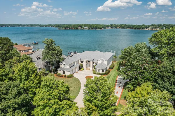 an aerial view of a house with a lake view