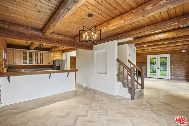 a view of a house with a small yard and wooden fence