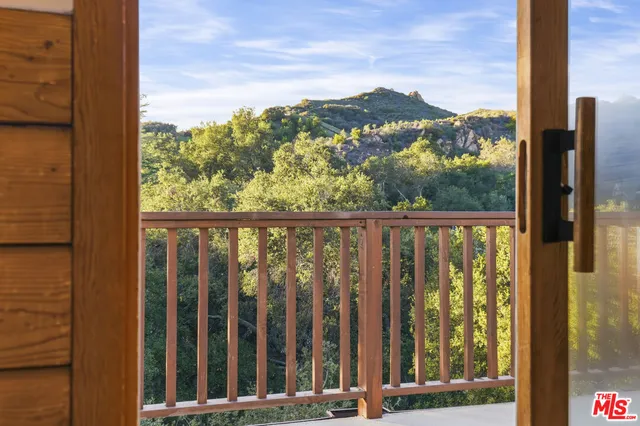 a view of an empty room with fireplace and a window