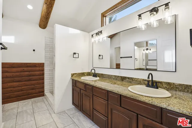 a view of a hallway with wooden floor and stairs