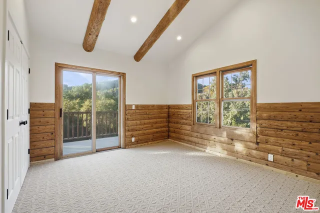 a balcony with wooden floor and fence