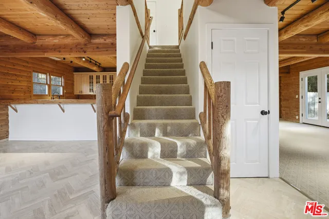 a view of empty room with floor to ceiling window and fireplace