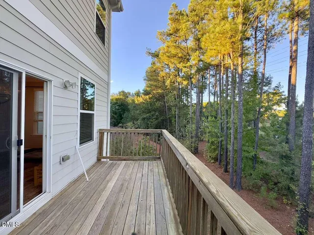a view of balcony with wooden floor and gate