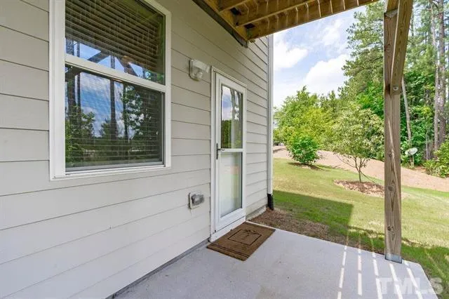 a view of a patio with table and chairs and potted plants