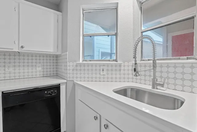 an empty room with closet and a chandelier fan