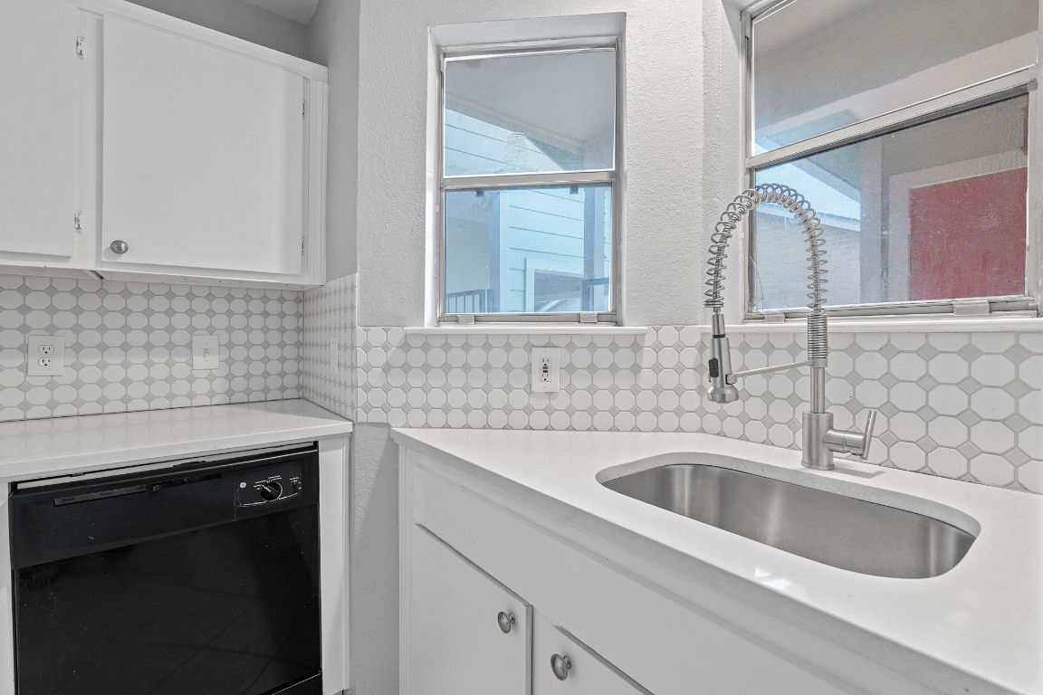 2104 Cullen Avenue, Unit 4224 Austin, TX 78757 - Photo 13 of 24 a kitchen with sink a stove and cabinets